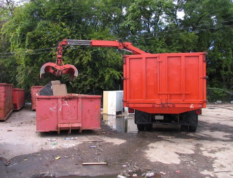 Workers sorting recyclables at a depot